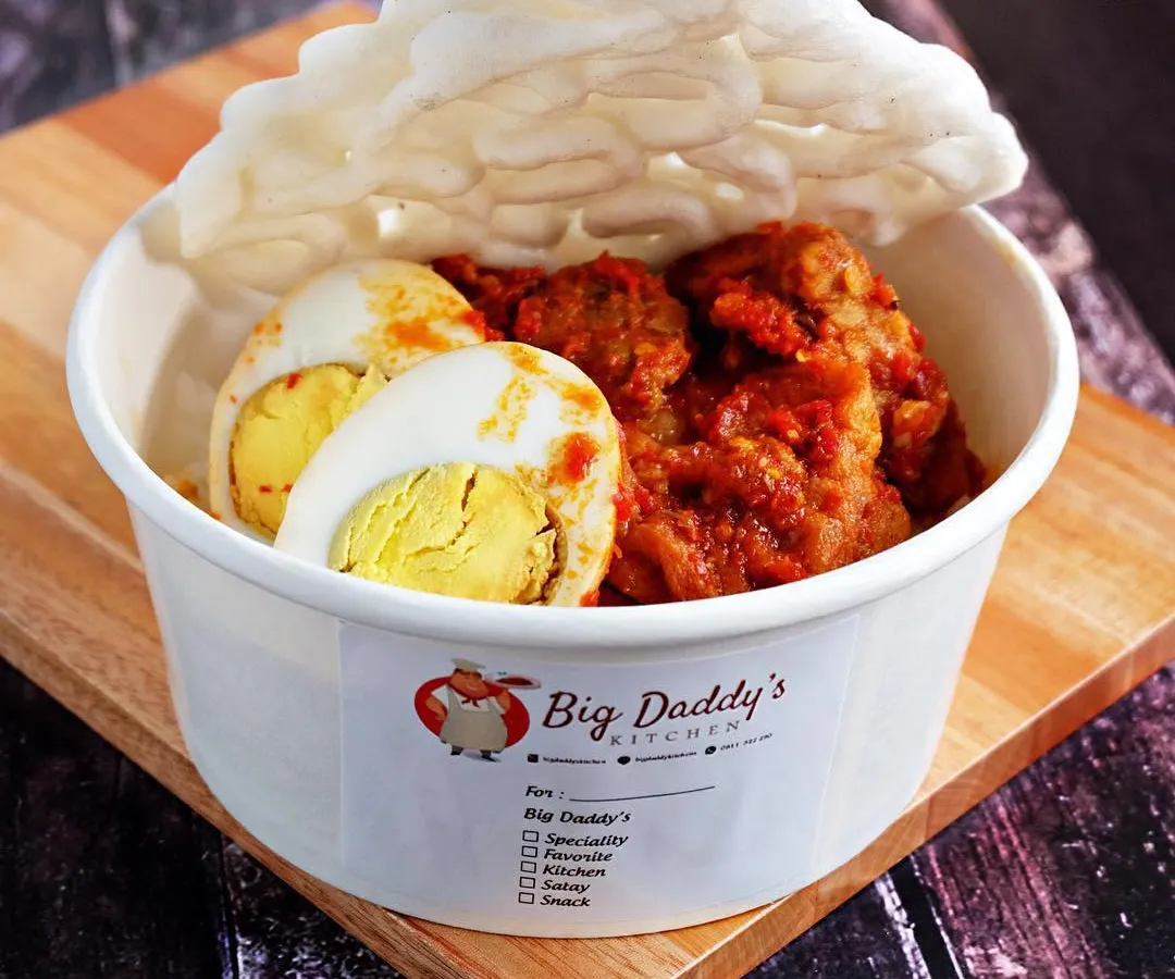 My Nasi Bali Pedas is a full meal in a bowl. It's packed with spicy meat, a whole boiled egg, and served on rice, all smothered in my signature red chili sauce. And of course, you get a giant, crunchy kerupuk on top!