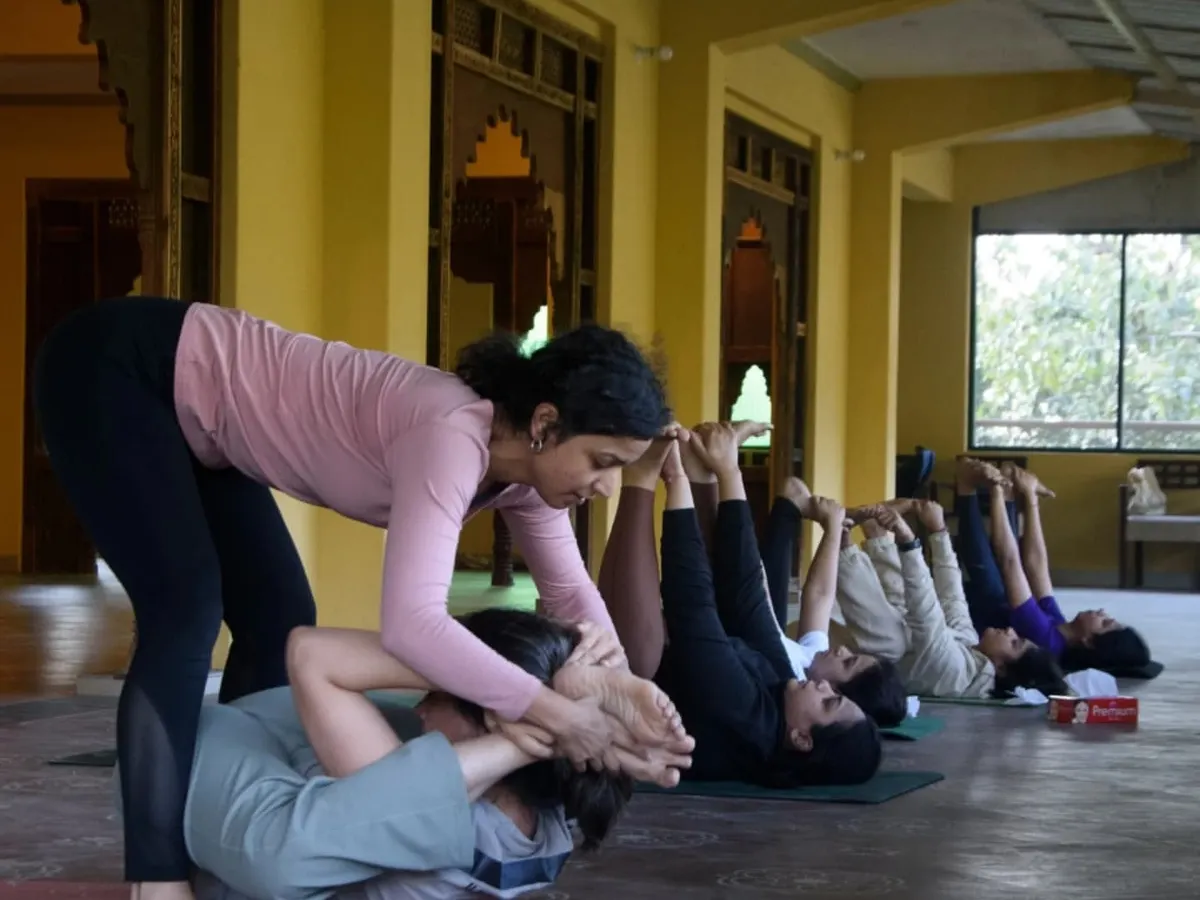 A core part of my retreats is providing hands-on, personal guidance. Here, I'm helping a student find a deeper expression in her pose during our Dehradun retreat, ensuring she feels supported and safe in her practice.