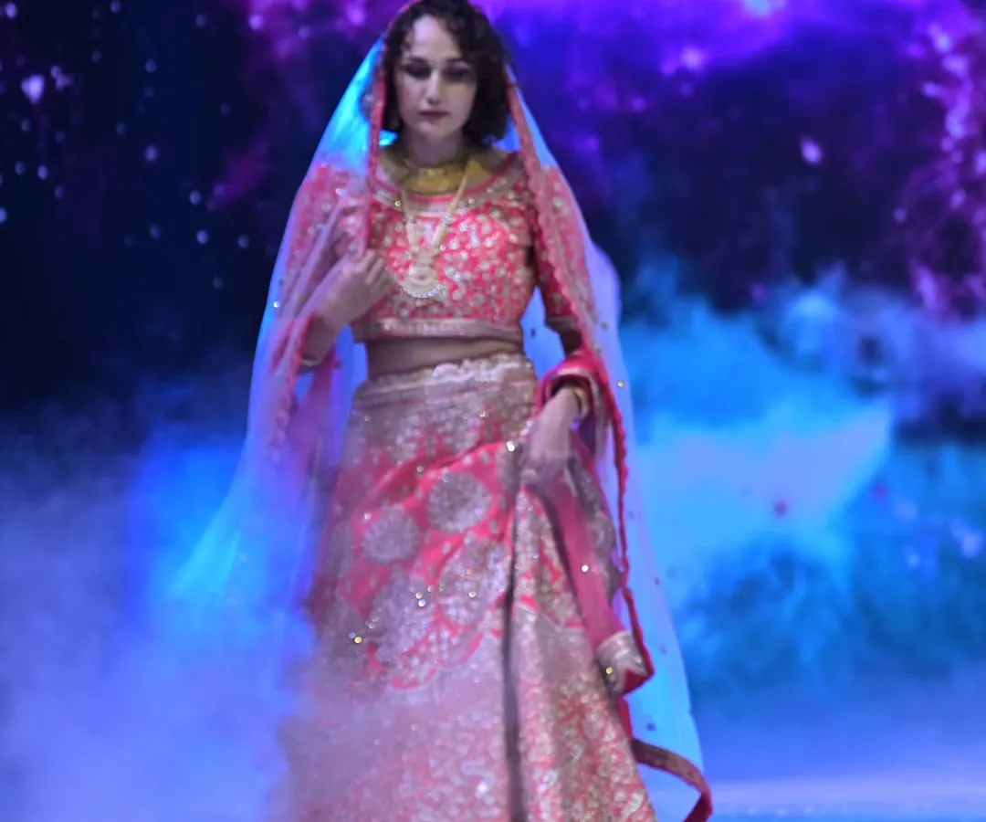 For the bride who loves drama and tradition, I created this opulent red lehenga. The rich embroidery and luxurious fabric are designed to make a powerful statement, blending classic Indian artistry with a modern, regal presence.