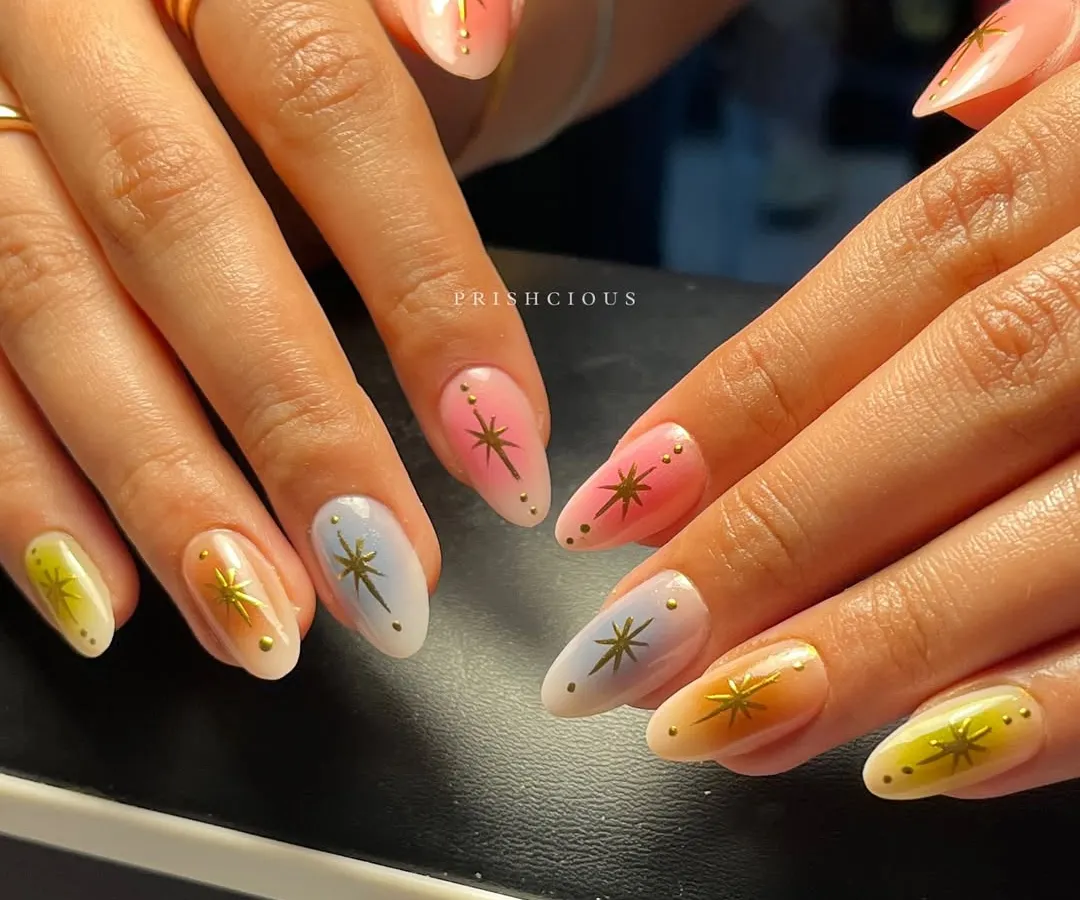 Aura nails are such a vibe, and this set is a total fav. I created a soft, multi-color gradient on each nail using dreamy pastels like pink, yellow, and blue, then topped them with delicate gold starbursts for that extra sparkle.
