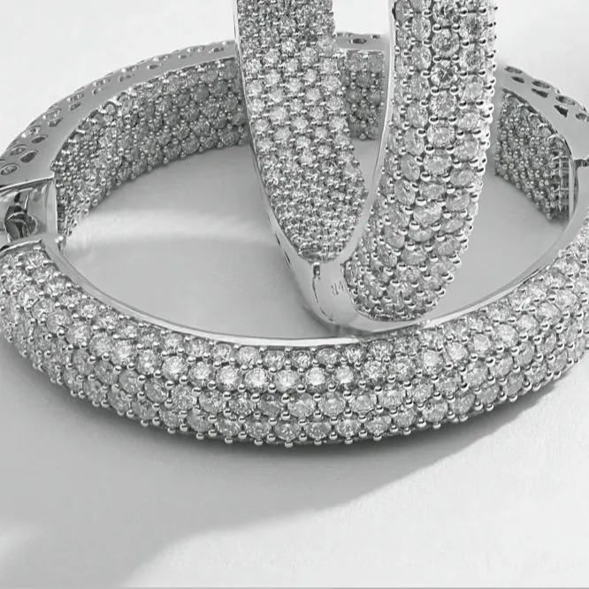 This macro photograph captures the intricate detail of pavé-set diamond hoop earrings. Every single diamond is in sharp focus, demonstrating the precision required for high-end e-commerce imagery where texture and quality are paramount.