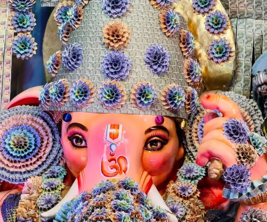 A close-up view of the Lord Ganesha idol, where the mukut (crown) and garlands are intricately crafted from folded currency notes. This highlights the detailed artistry and devotion I bring to every aspect of my decoration work.