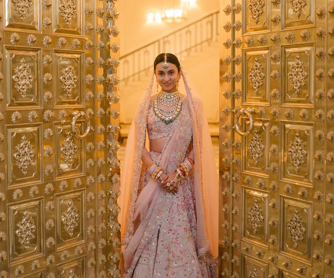 A bride's grand entrance is a moment of pure magic. I worked with Vibha to style her Anamika Khanna lehenga and the decor, ensuring her reveal through these magnificent golden doors at Mementos by ITC Hotels felt nothing short of royal.