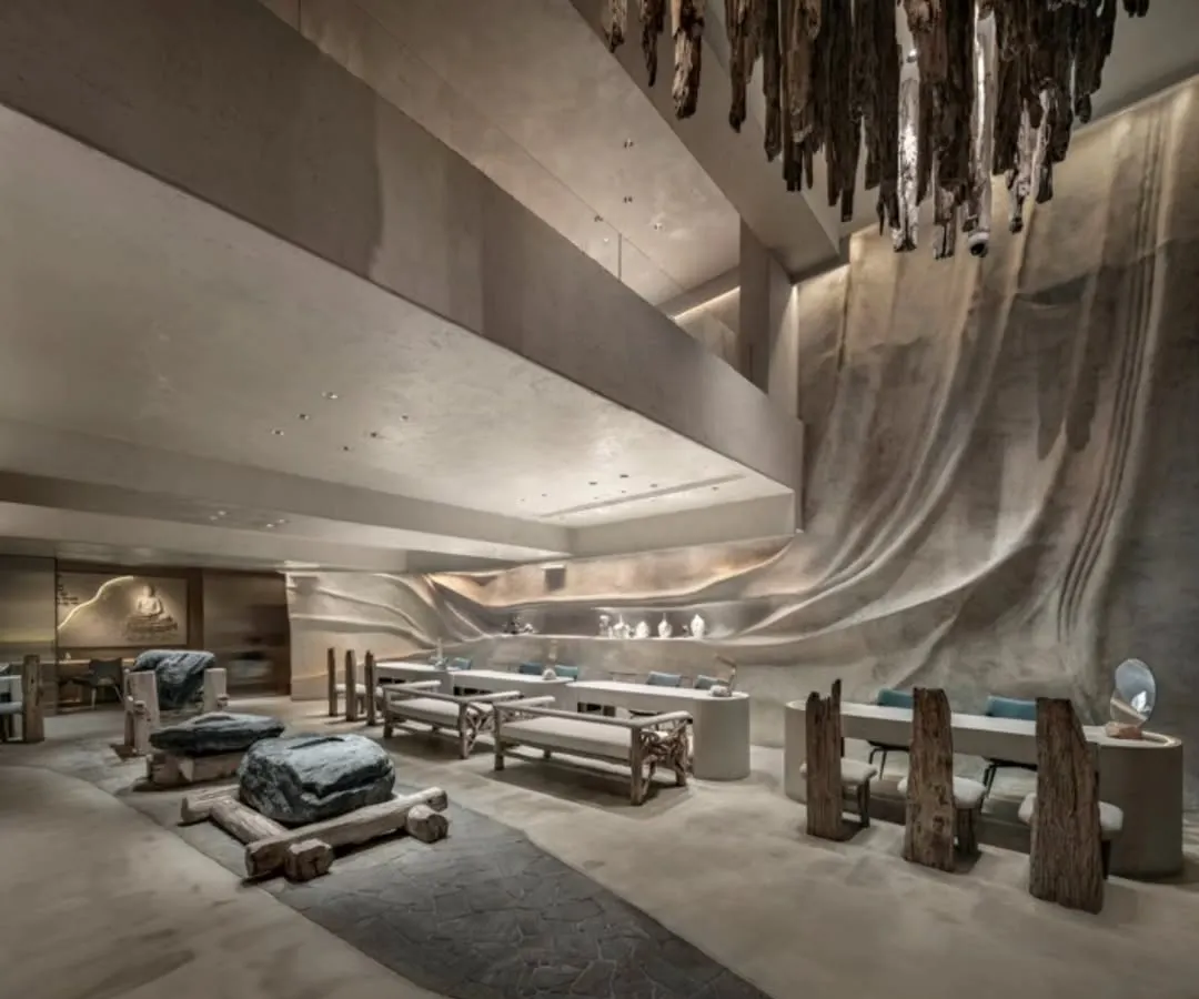 For the La Solitaire jewellery showroom, I wanted to create a space that felt like discovering treasure within the earth. This view shows how we used a driftwood chandelier, sculptural stone seating, and fluid, cave-like walls to craft a retail experience that is about contemplation and raw, natural luxury.