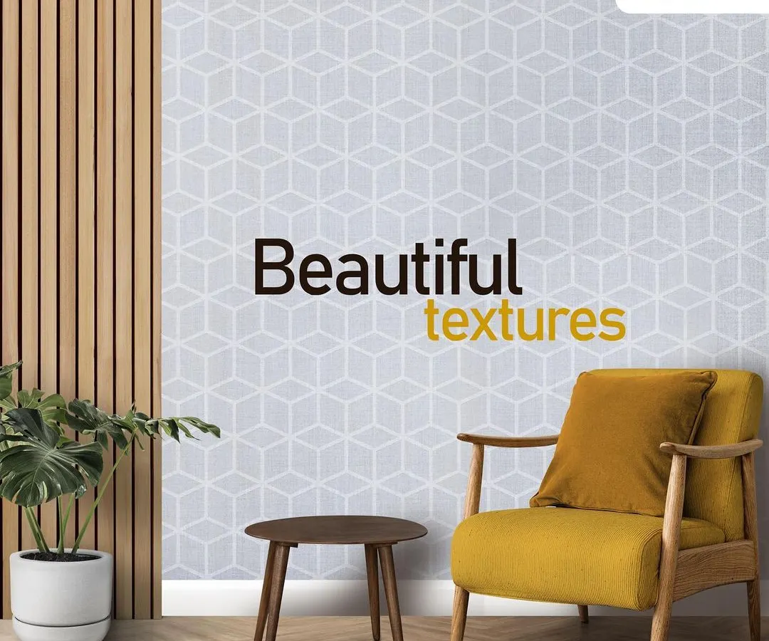 A modern living space featuring a stunning accent wall with a light grey geometric cube pattern. This textured wall finish adds depth and a contemporary feel, perfectly complemented by the minimalist wooden furniture and a pop of colour from the yellow armchair.