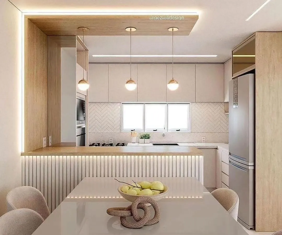This open-concept kitchen and dining area is a testament to our 3D visualization process, allowing you to see your dream space before we build. Notice the seamless integration of the breakfast counter, ambient lighting, and fluted panel details that add texture and warmth.