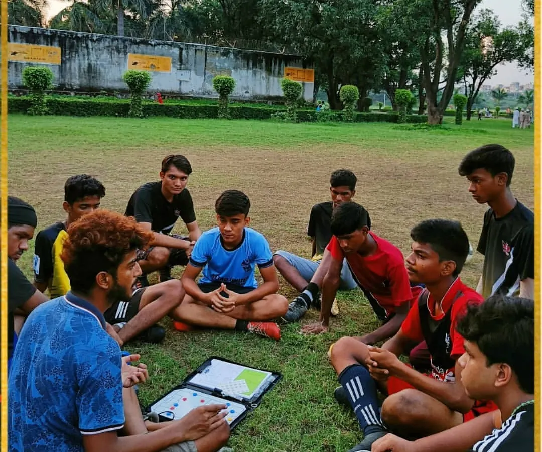 We believe a smart player is a strong player. Here, we are using a tactical board during a session to discuss game strategy, positioning, and on-field communication. This is how we build game awareness.