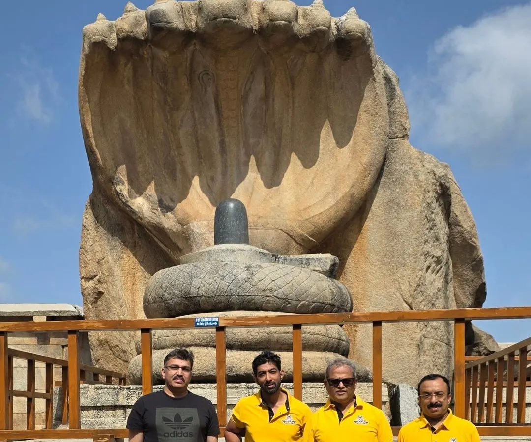 Our group in front of the massive Naga Linga statue at Lepakshi. These heritage tours are not just about riding; they are about experiencing the scale and stories of South Indian history together.