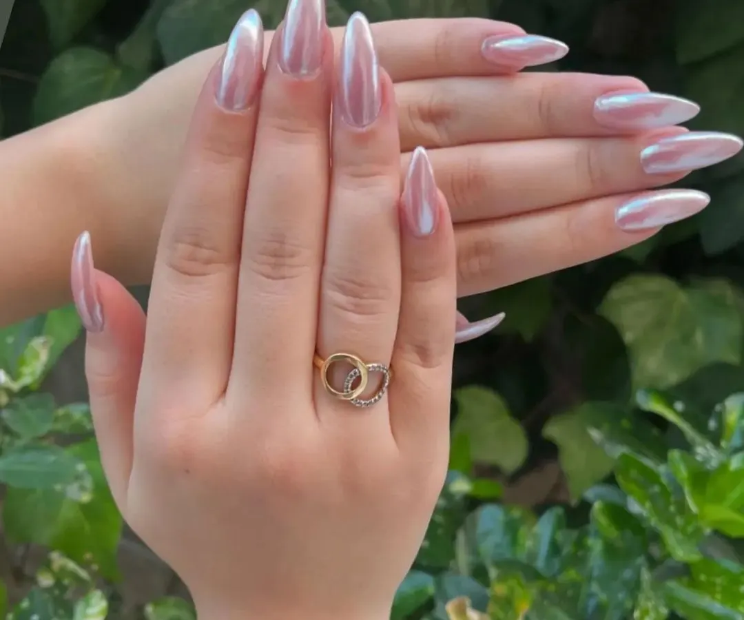 A stunning example of the popular chrome nail trend. I used a high-quality chrome powder over long stiletto extensions to create this liquid-metal, pearlescent effect that shifts beautifully in the light. This look is modern, chic, and incredibly eye-catching.