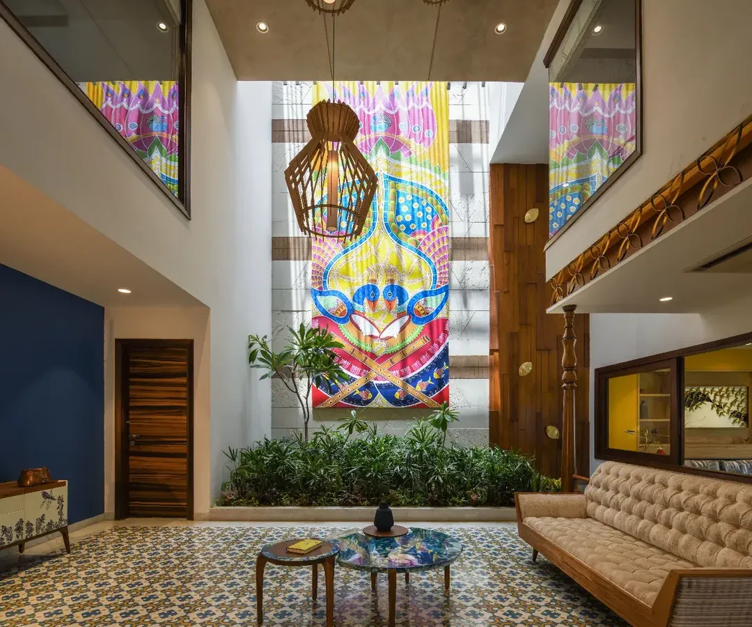 The heart of the Ashraya Residence is this double-height courtyard, where a 28-foot painting of Lord Krishna becomes a spiritual and visual anchor. The space is a modern interpretation of the traditional Indian 'aangan', filled with light, art, and life.