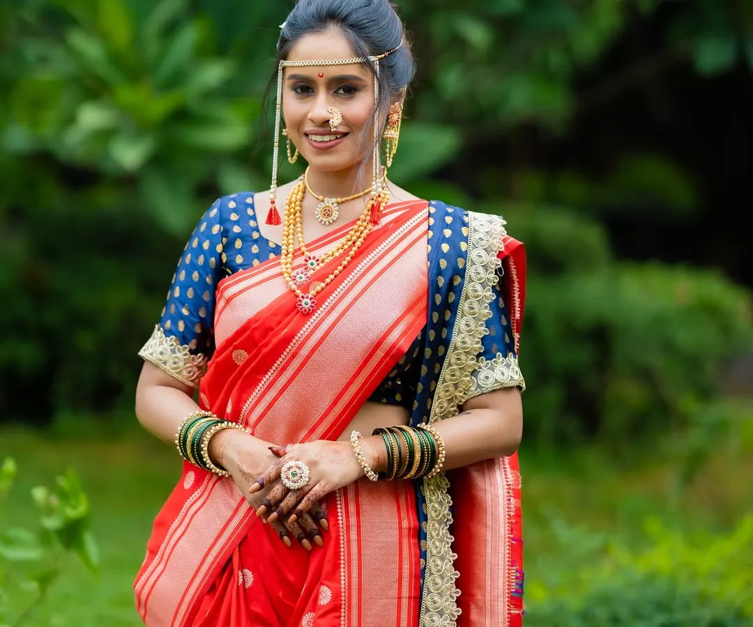 A classic Maharashtrian bride in a radiant red Paithani Nauvari. I styled this entire look, from the precise drape and minimal makeup to the traditional mundavalya and jewelry, ensuring she felt both royal and comfortable on her big day.