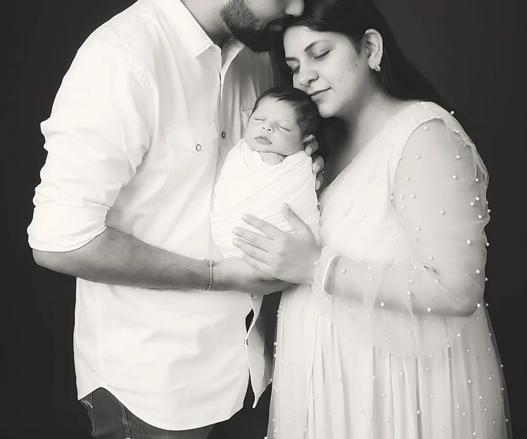 A classic black and white family portrait that becomes an instant heirloom. In this quiet, timeless frame, all that matters is the connection between new parents and their precious baby. This is the kind of powerful, emotive photography I create to tell your family's story for generations.