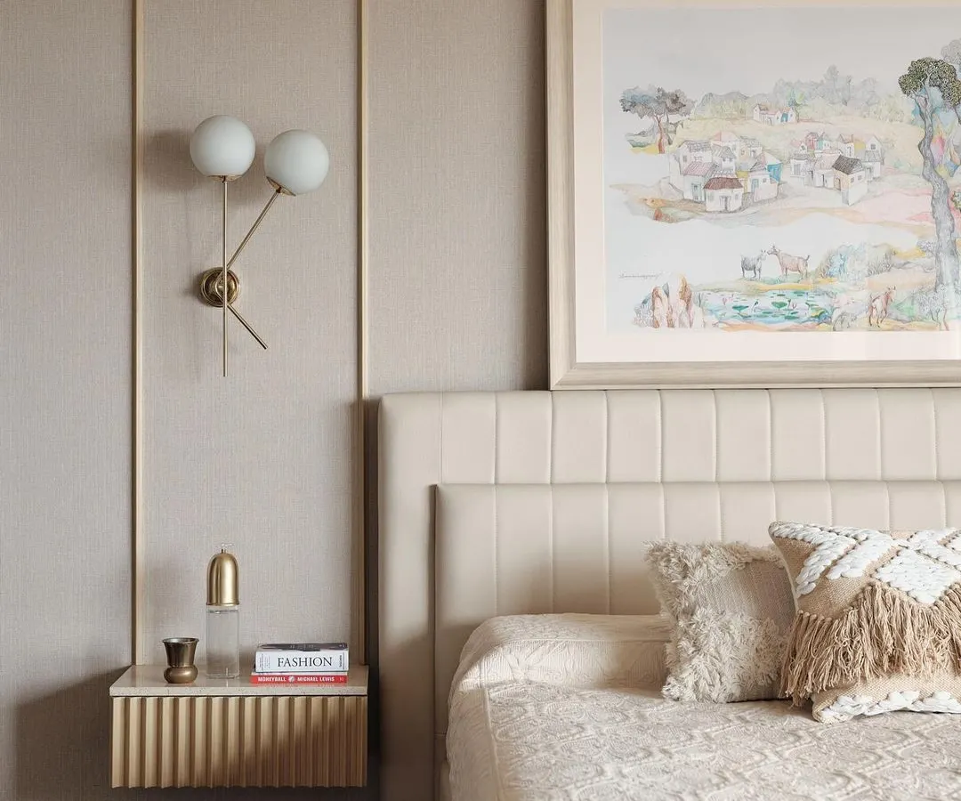 In this master bedroom, I aimed for a calm and sophisticated retreat. The design features a fabric-panelled wall, bespoke fluted bedside tables, and soft, layered textiles to create a warm and inviting atmosphere. The artwork was chosen to complement the serene, neutral tones of the room.