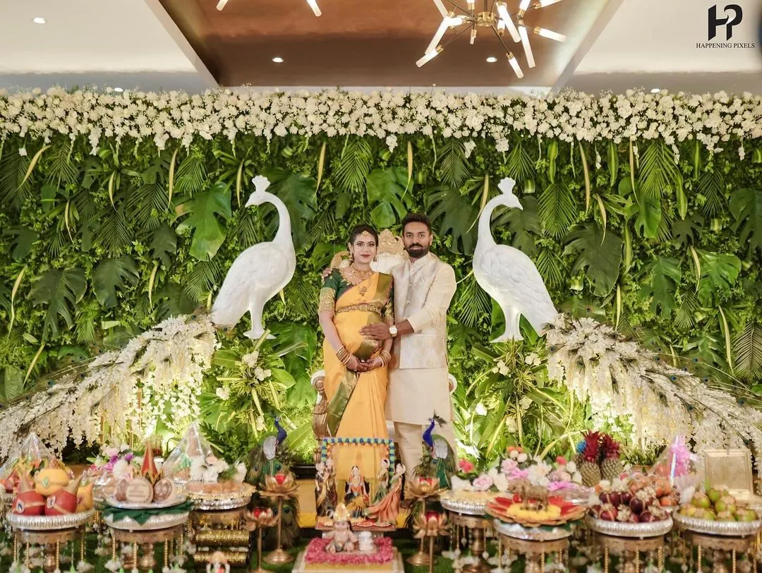 It's a joy to see couples surrounded by the beauty of their celebration. Here, I designed a lush green peacock-themed backdrop and a full traditional plate display for a memorable baby shower.