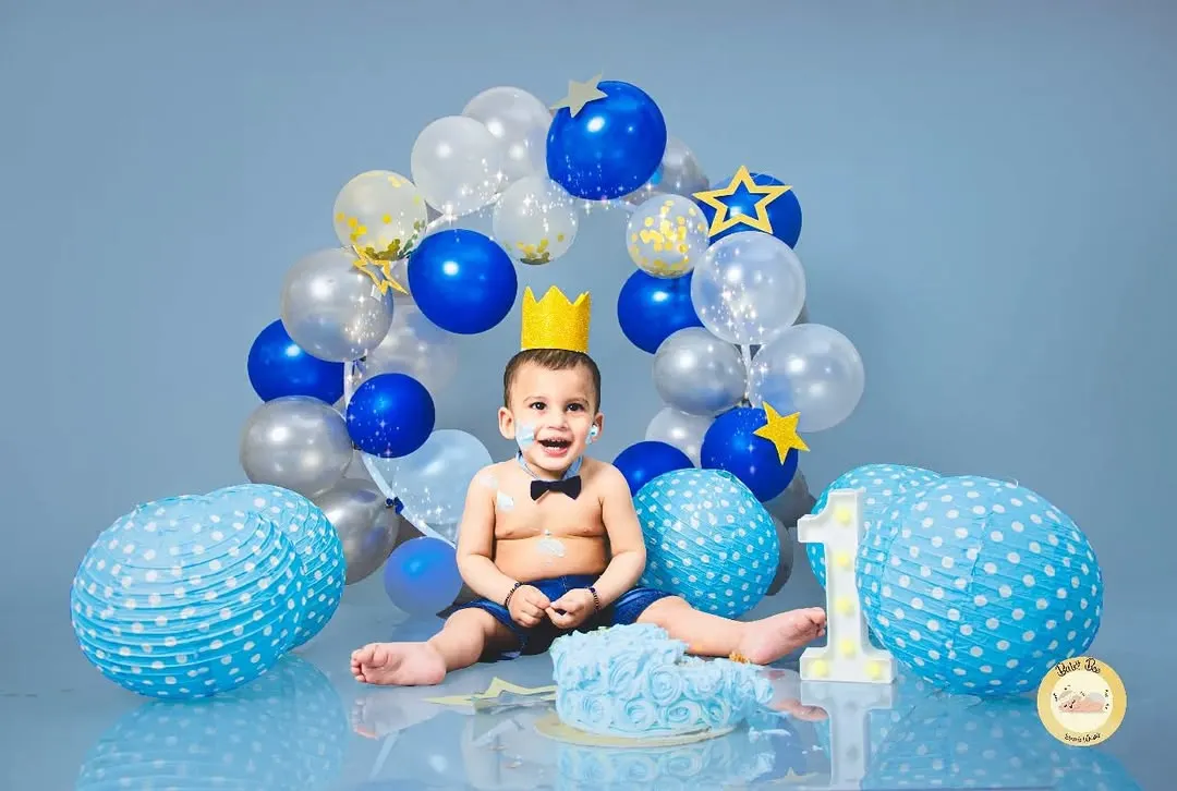 Nothing says "birthday" like a cake smash! We love capturing the pure, messy fun as little ones dive into their first taste of cake. This blue-themed setup shows a classic, happy cake smash moment.
