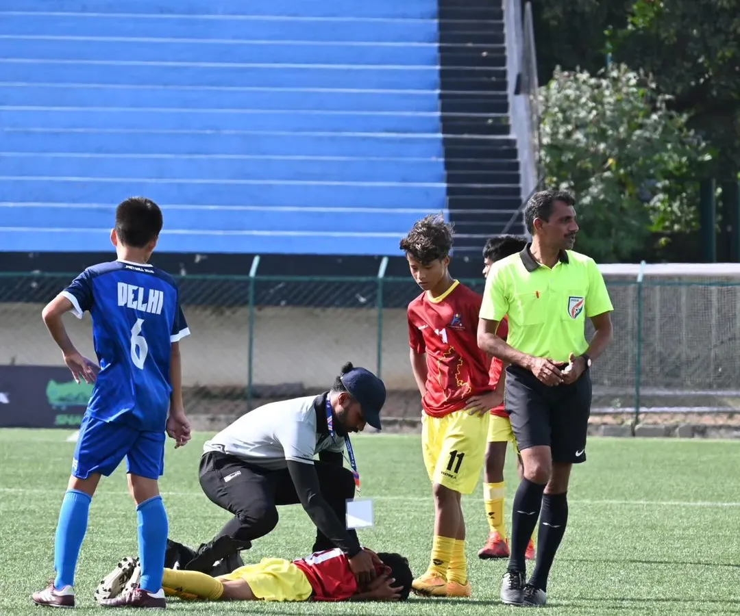In the heat of the moment, immediate care is crucial. Here I am providing on-field first aid to a young football player during a match, ensuring a swift and professional response to a sports injury.