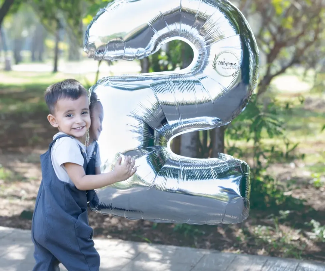 Two years old and full of smiles. I focus on making birthday milestone shoots fun and relaxed, letting your child's personality shine through. This outdoor portrait captures that wonderful, playful energy of being a toddler.