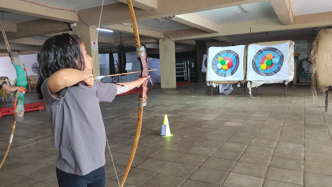 This is what pure focus looks like. I guide every student, young or old, to find their stance, steady their hand, and let the arrow fly. It all starts with learning the correct form.