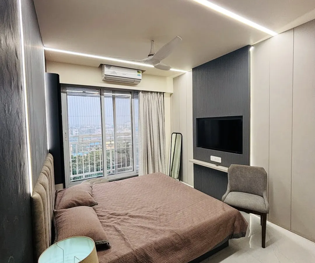 I designed this master bedroom to be a cozy retreat. The combination of dark textured wall panels, soft ambient lighting from the ceiling, and an upholstered headboard creates a warm and inviting modern bedroom.