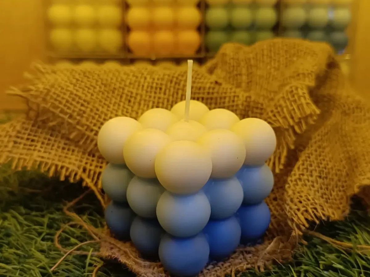 This is my triple-color ombre bubble candle, a modern sculptural piece that adds a pop of color to any room. Each one is hand-poured to create this unique gradient effect.