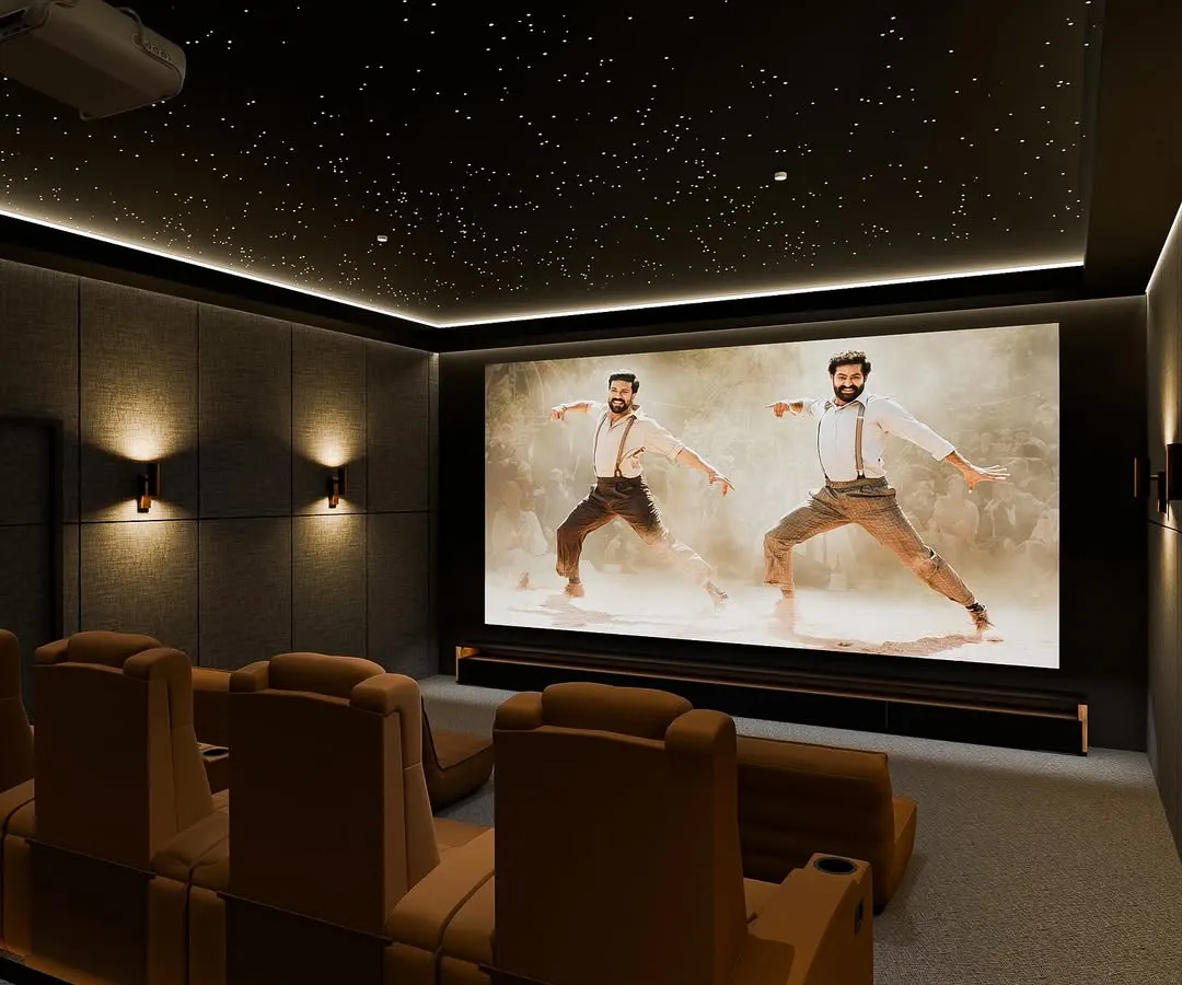 Look up and get lost in the cosmos with our signature starlight ceiling. This 'Stellar Luxe' design features a fiber optic galaxy effect, premium acoustic wall panels, and plush tan recliners, creating a warm yet breathtaking atmosphere for an immersive viewing experience.