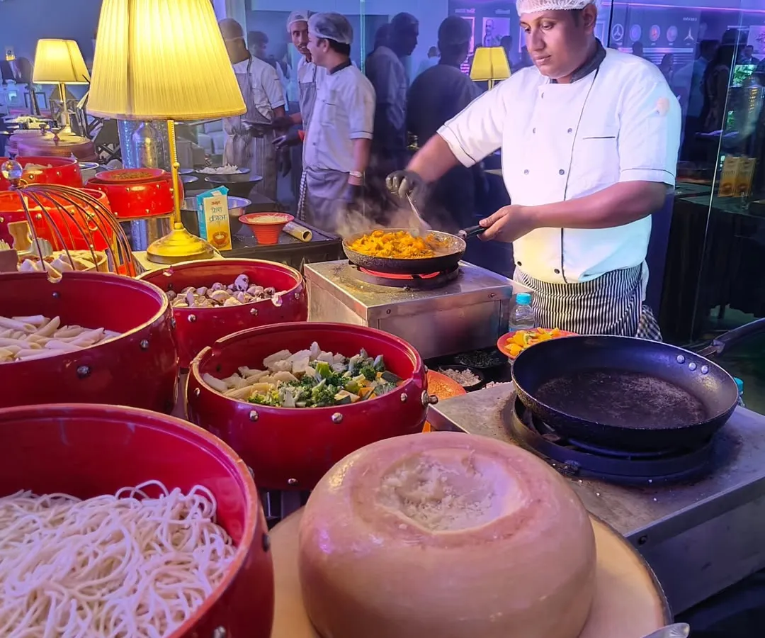 A live pasta station in action at the Landmark Mercedes launch for their new EQ model. We bring the kitchen to your guests, creating fresh, customized dishes like this pasta being finished in a wheel of Parmesan cheese for a touch of culinary theatre.