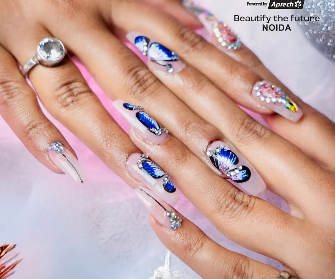 Master intricate, theme-based designs like this stunning butterfly nail art. Our courses cover detailed techniques for creating delicate patterns and applying rhinestone embellishments for a high-end finish.