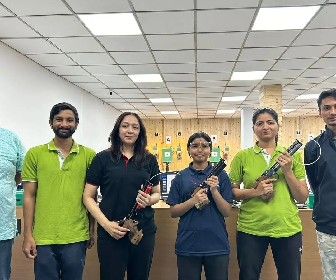 A group of adults after a recreational shooting session, holding both air pistols and air rifles. My sessions are a popular activity for friends and corporate teams looking for a new experience.