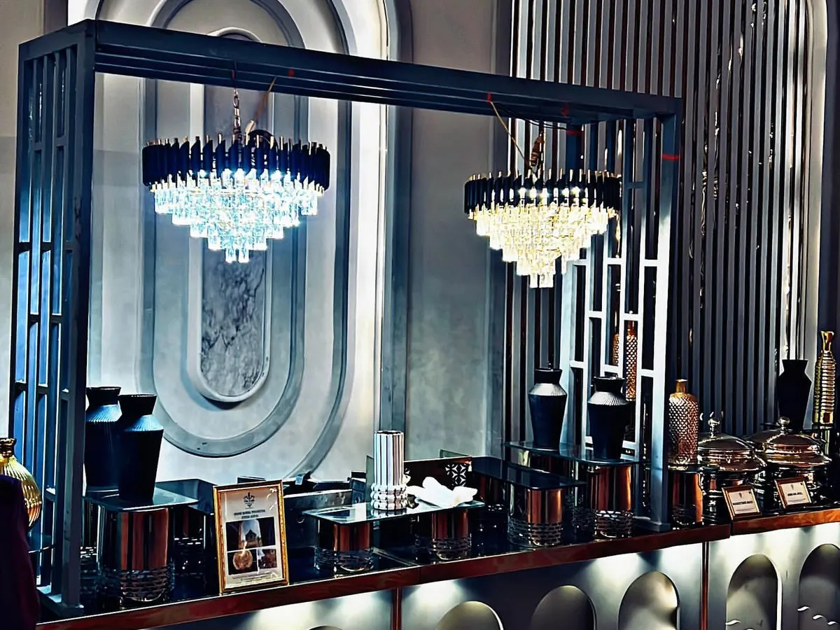 Our modern and architectural buffet setups are designed to integrate seamlessly with your event's decor. This display features dramatic chandeliers and clean lines, demonstrating our commitment to creating a sophisticated dining atmosphere.