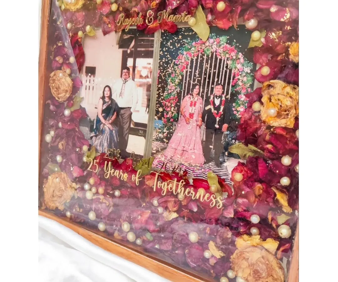A 25th anniversary is a milestone of love worth celebrating and preserving. For this special gift, I used the couple's original wedding flowers, photos, and names in a beautiful teakwood resin frame to honor their incredible journey together.
