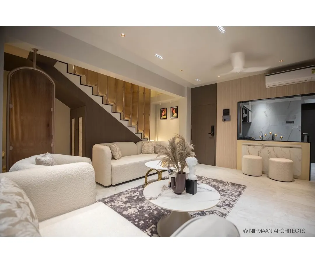 This is the heart of our Duplex Project, a contemporary living room designed for comfort and quiet luxury. We focused on a warm, neutral palette, plush textures, and a statement staircase with integrated lighting to create an inviting and sophisticated atmosphere.