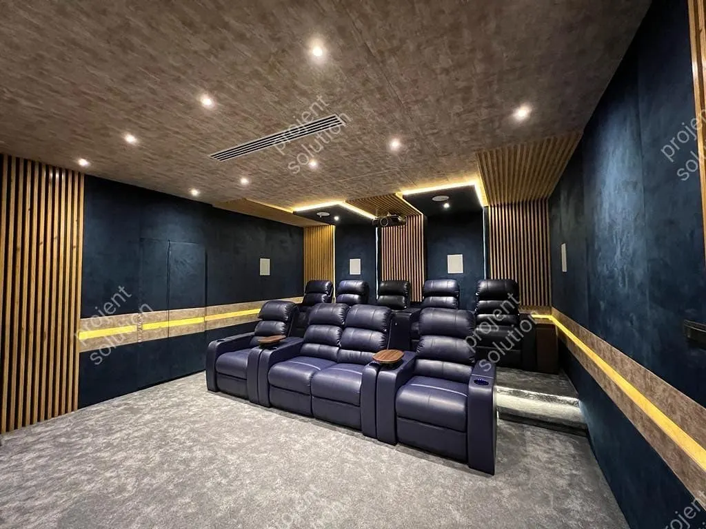 This project showcases a complete home theater solution with luxurious, two-tiered navy blue motorized recliners. The design integrates wood slat panels and dark blue fabric for superior room acoustics and a sophisticated aesthetic.