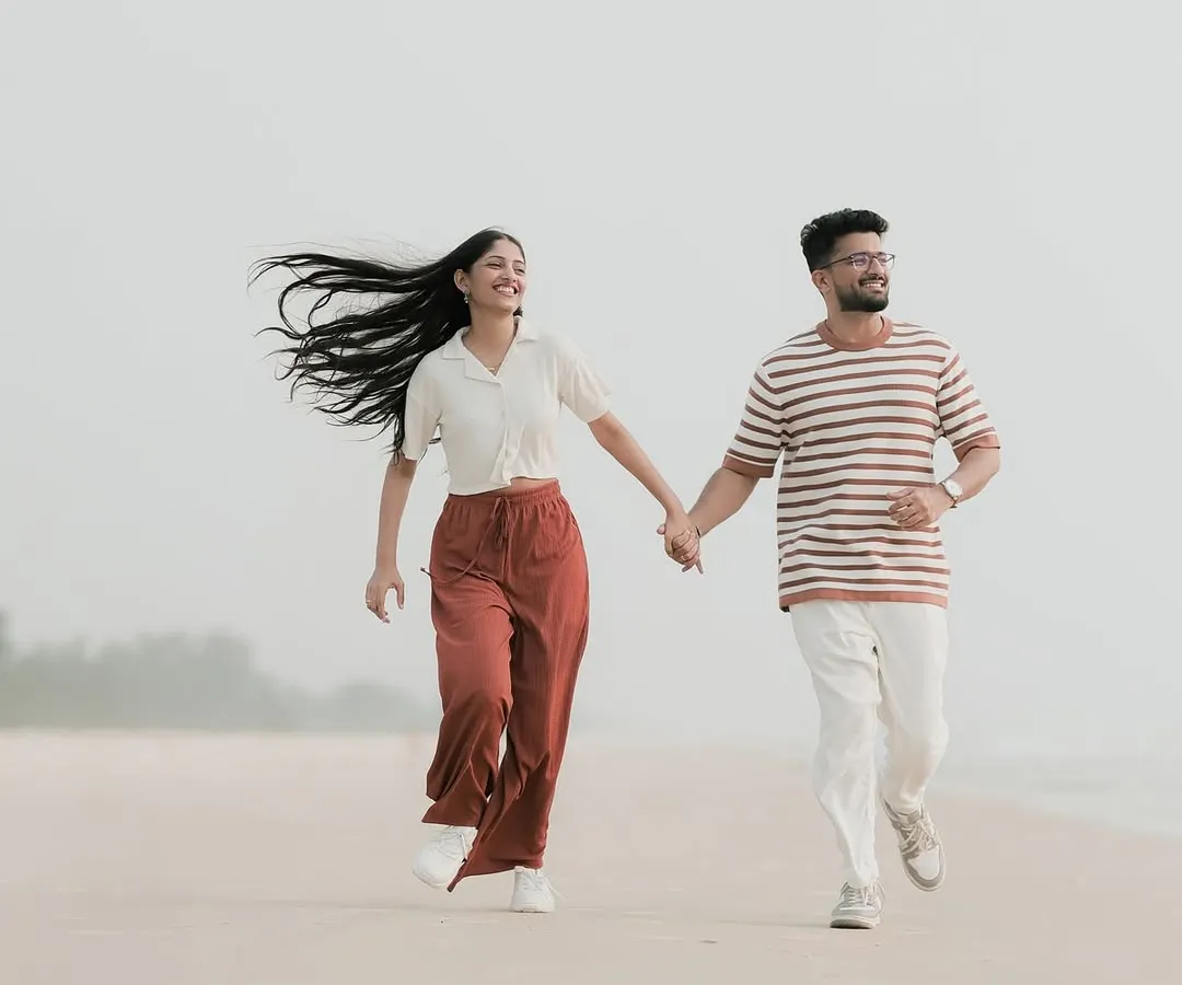 The pure joy of running together on a quiet Mangaluru beach. I focus on capturing these energetic, unposed moments where your personalities shine through, creating memories filled with laughter.