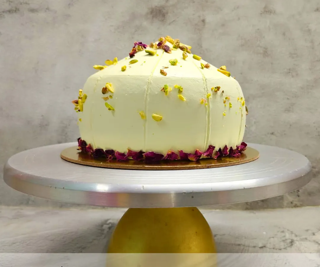 For Ganesh Chaturthi, I offer a modern take on a traditional sweet with my signature Modak Cake. This 100% eggless cake is shaped like a modak and delicately flavored, garnished with premium pistachios and edible rose petals for an elegant finish.