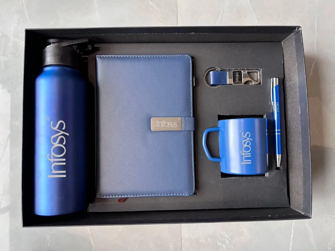 I create fully branded corporate gift sets, like this one for Infosys. This combo includes a 750 ML bottle, an A5 diary, a steel mug, a pen, and a keychain, all in a striking blue and customized with the company logo. This is a great option for employee onboarding kits or client appreciation gifts.