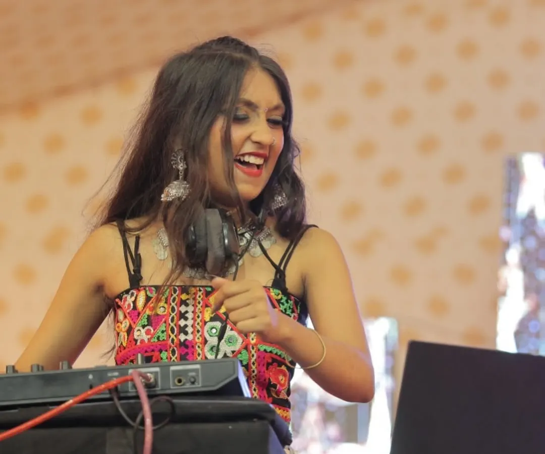 A close up of me in the zone, mixing tracks and feeling the beat. This smile is genuine because I truly love turning a regular Garba night into an unforgettable party.