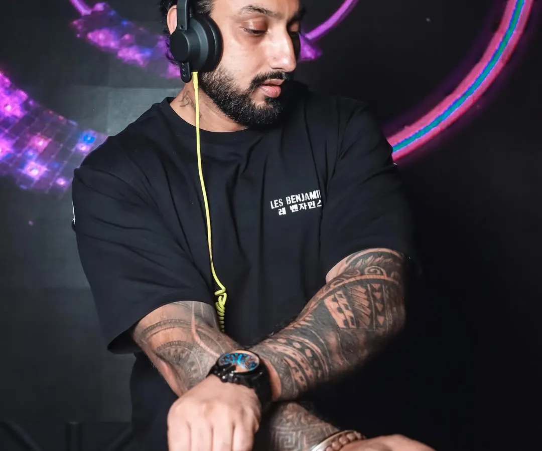 In the zone, crafting the perfect set. Every track is chosen to build momentum and create a unique musical journey, whether it's commercial hits, deep house, or Bollywood bangers.