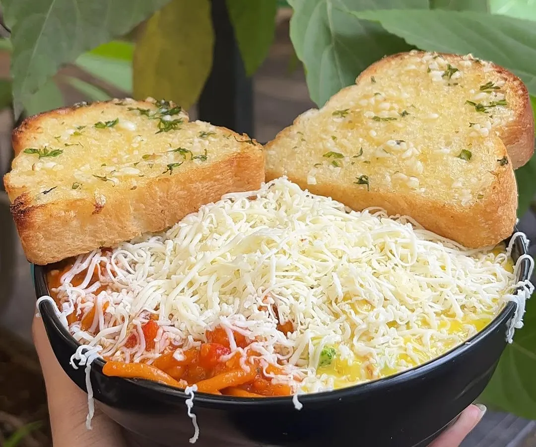 Can't decide between red or white sauce? With my special Pasta & Pasta, you don't have to. I serve both creamy white sauce and tangy red sauce pasta in the same bowl, topped with plenty of cheese and served with garlic bread.