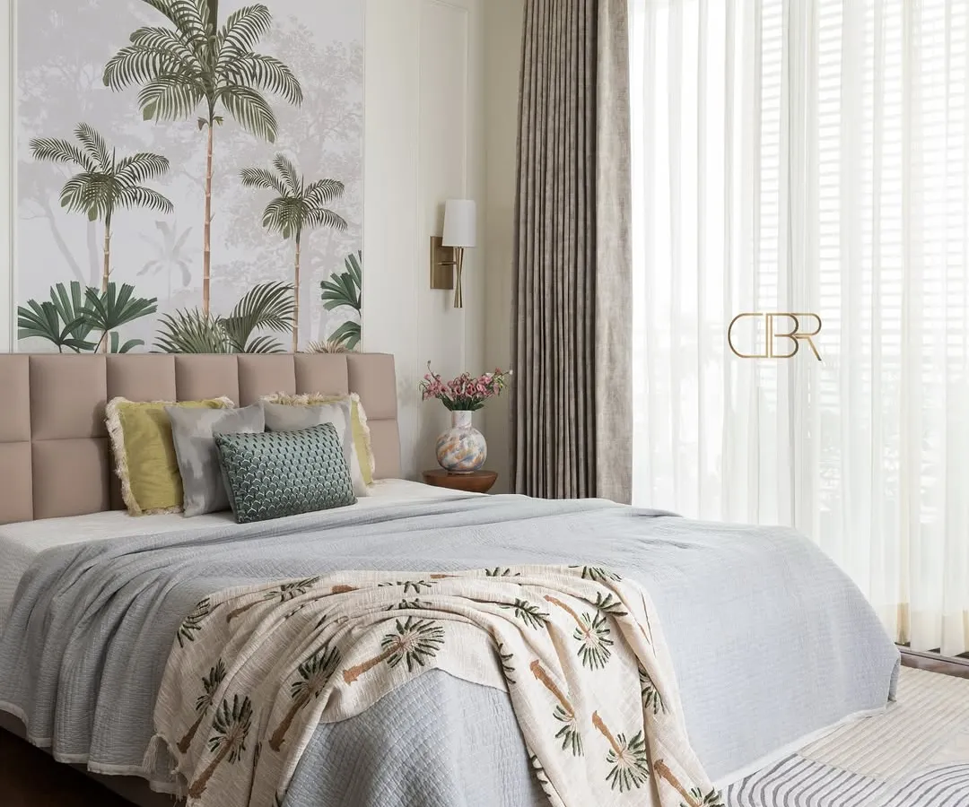 A bedroom should be a personal retreat, and for this master suite, I brought nature indoors with a custom tropical wall mural. The design balances this serene backdrop with a plush, tufted headboard and soft, layered textiles, creating a tranquil escape that feels both luxurious and grounded.