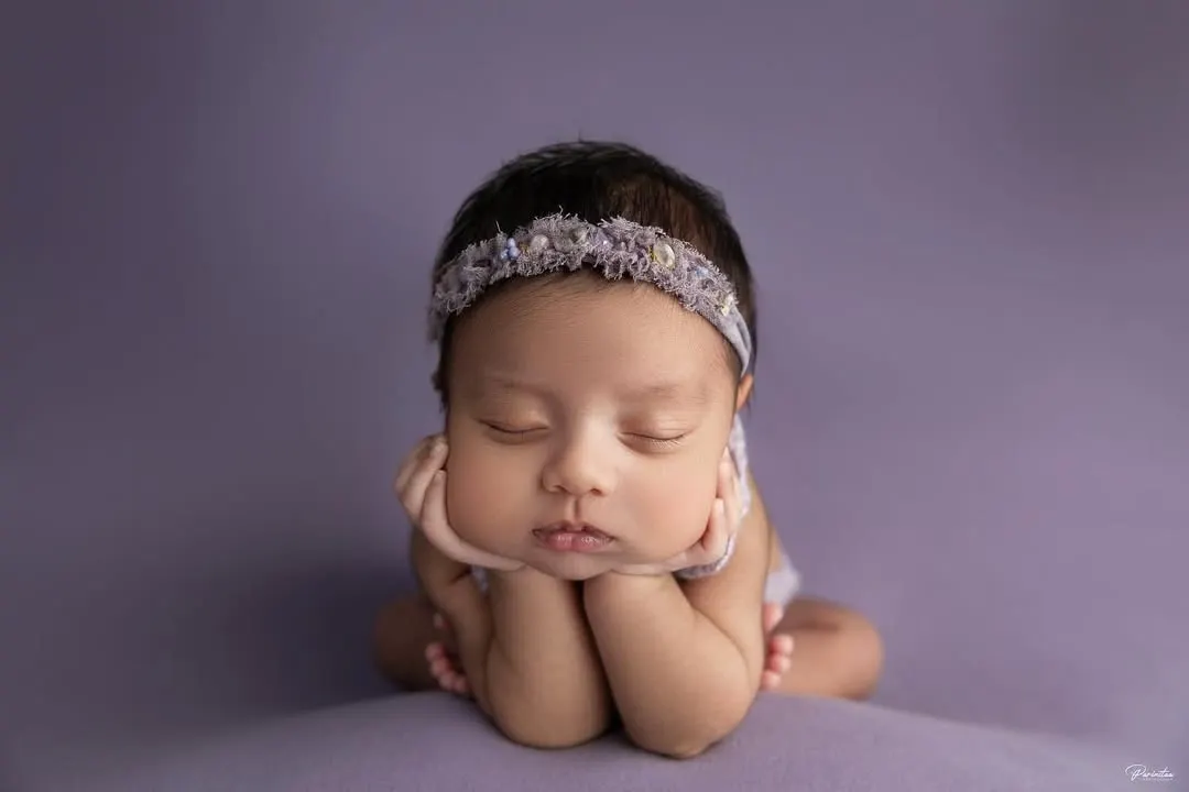 This is the magic of a classic newborn portrait. With gentle posing and soft lighting, I focus entirely on your baby's serene beauty, creating a simple, elegant, and timeless piece of art.
