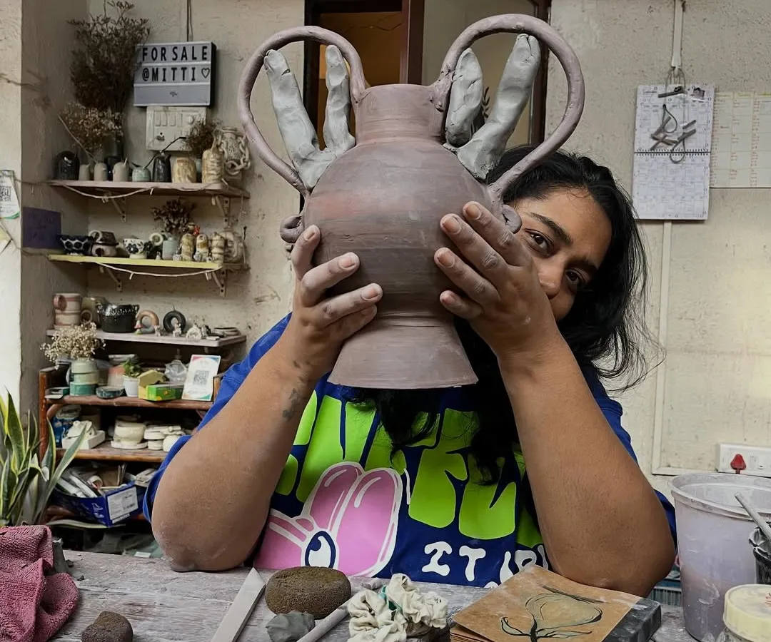 Here I am, peeking out from behind a new piece in the studio. This is my happy place, surrounded by mitti, works-in-progress, and endless possibilities. Every piece I make holds a little bit of this joy.