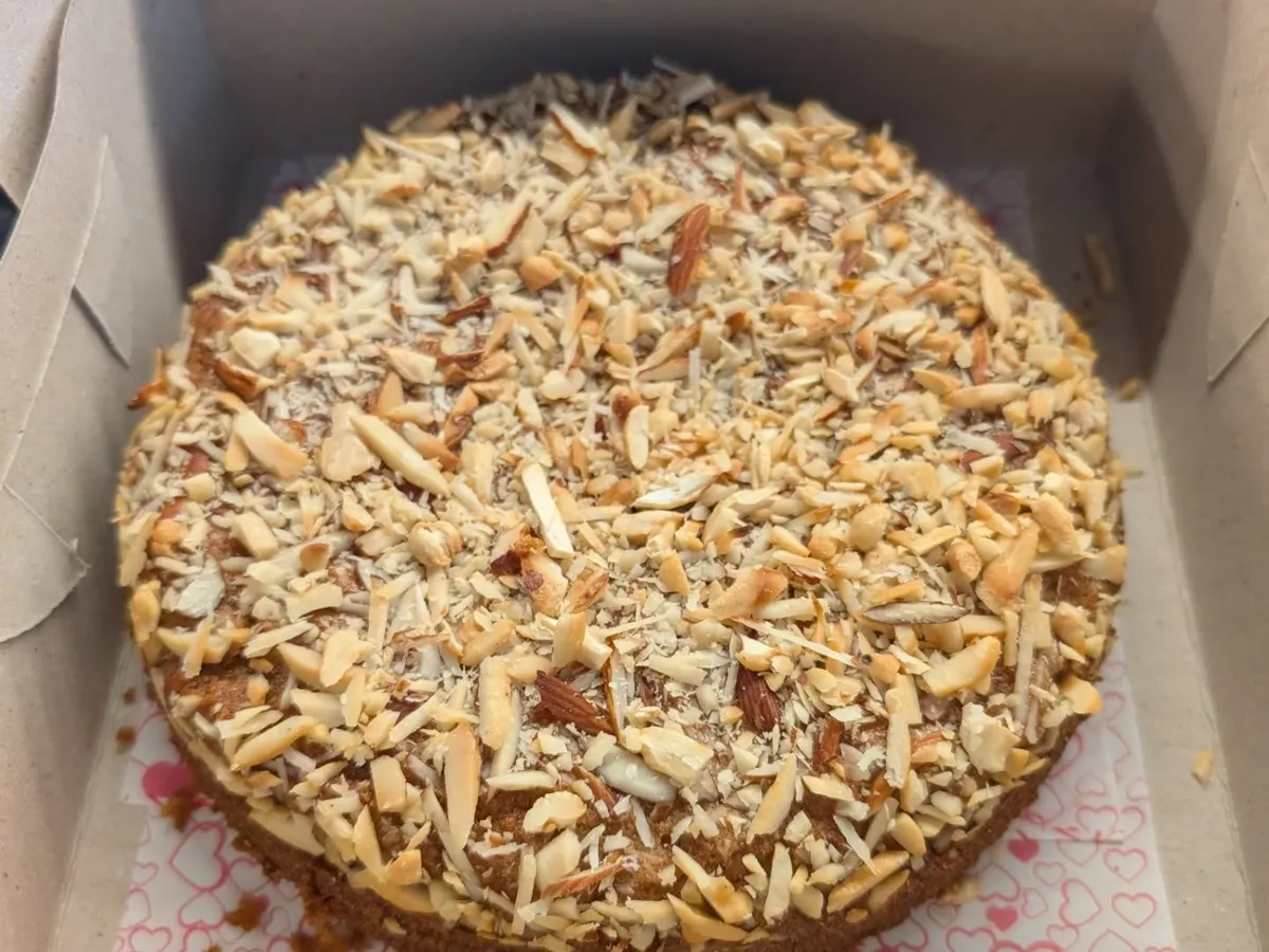 My almond dry cake is a favorite for tea time or as a simple, elegant dessert. It's a dense whole wheat and jaggery cake generously topped with toasted, sliced almonds for a wonderful crunch and nutty flavor.