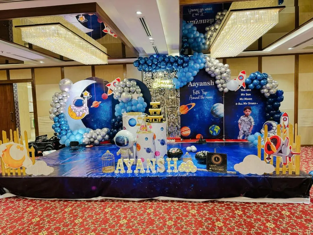 For the little explorer, I design out-of-this-world space themes. This setup features a floor-to-ceiling galaxy backdrop, custom astronaut and rocket cutouts, and a balloon arch in cosmic blues and silvers, making the birthday boy or girl the star of their own universe.