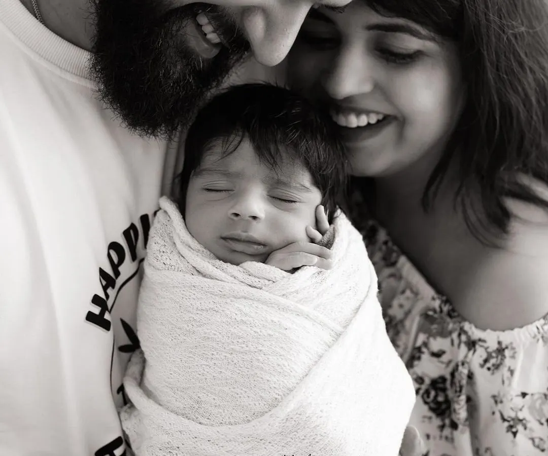 There's a special kind of magic in the first family portrait. This black and white image focuses on the pure joy and connection between new parents and their baby, a timeless memory of when your family grew.