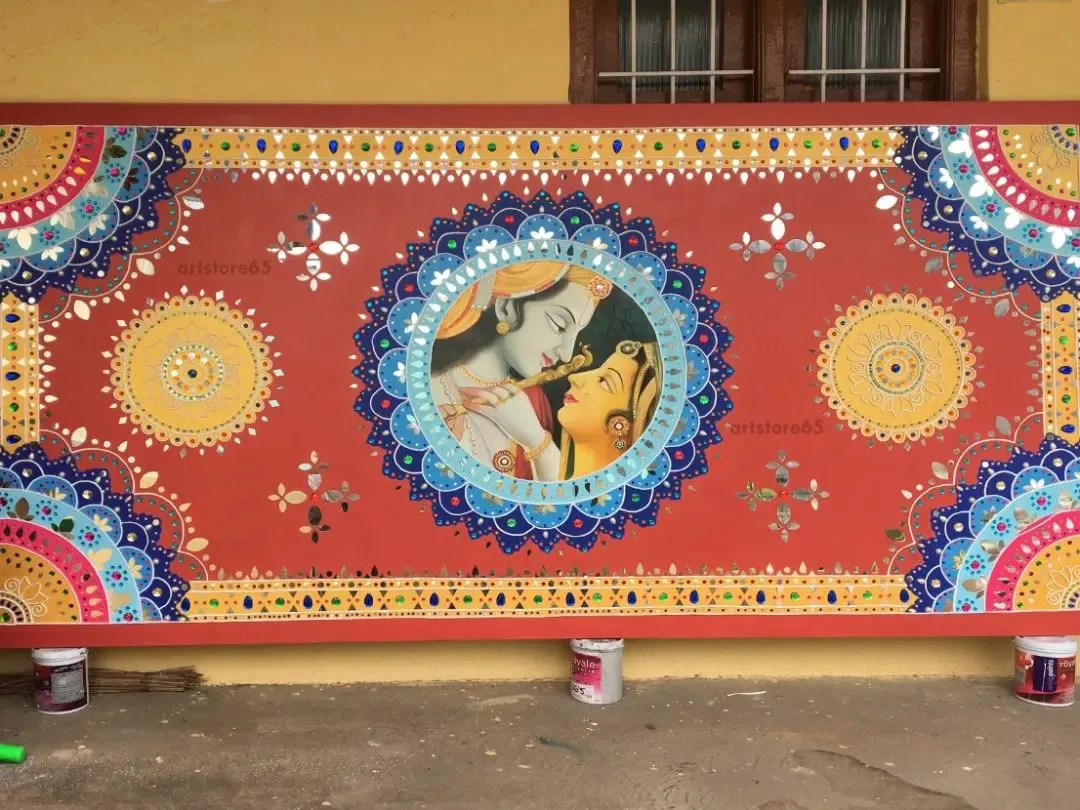 This is a custom Lippan art piece we created, featuring a central portrait of Radha and Krishna. The entire panel is handcrafted with intricate mirror work and traditional mandala patterns, bringing a rich, ethnic feel perfect for a home or a high-end showroom.