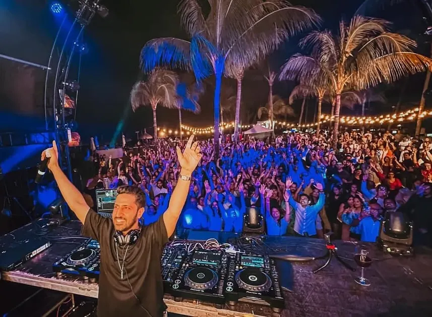 This is the view from my console in Mauritius, a sea of energy under the palm trees. It's moments like these, connecting with thousands of fans and feeling the collective joy, that define my performances at large-scale concerts and festivals.