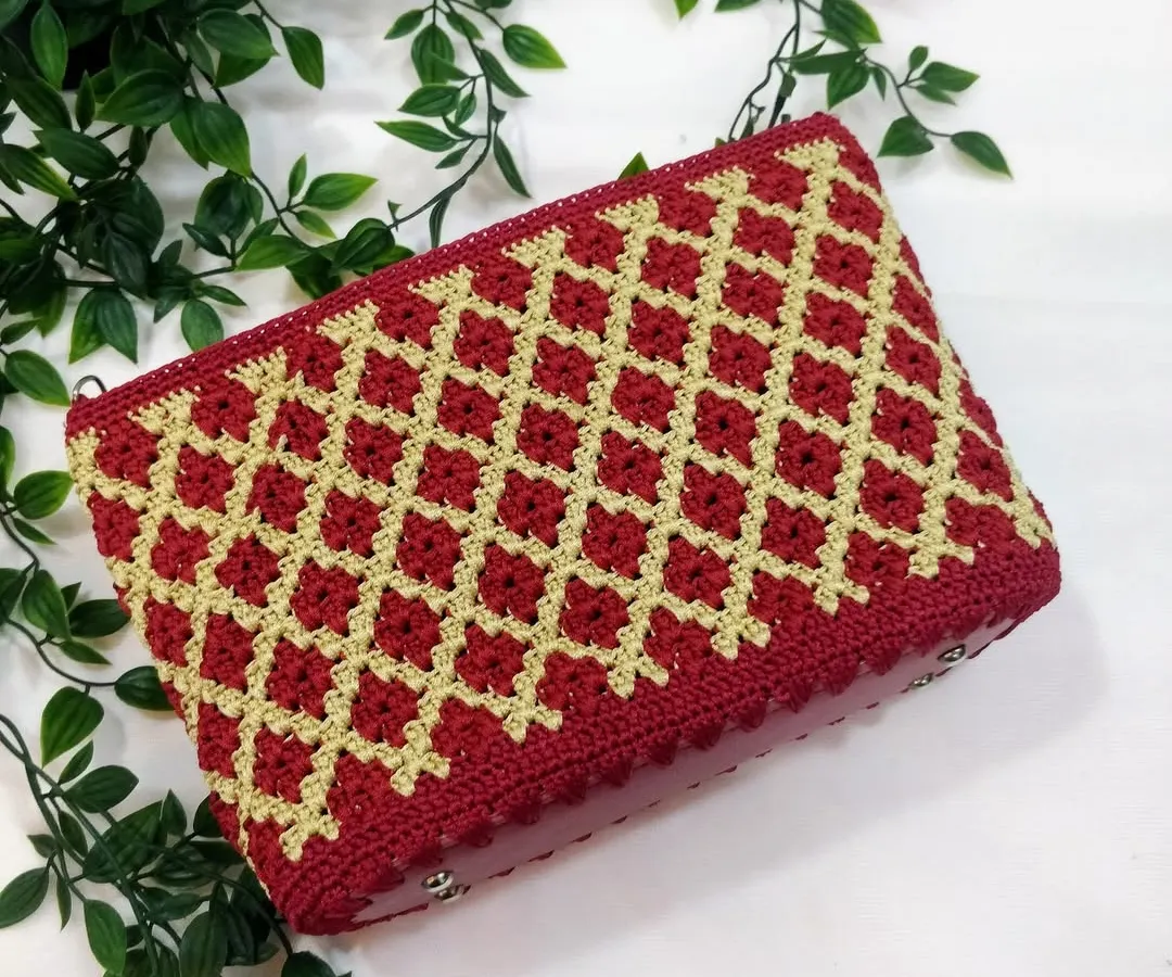 My signature diamond pattern clutch in a festive maroon and gold. This piece is a favourite for pairing with ethnic wear, and I take great care in getting every stitch just right. It's a timeless design that I love to create.