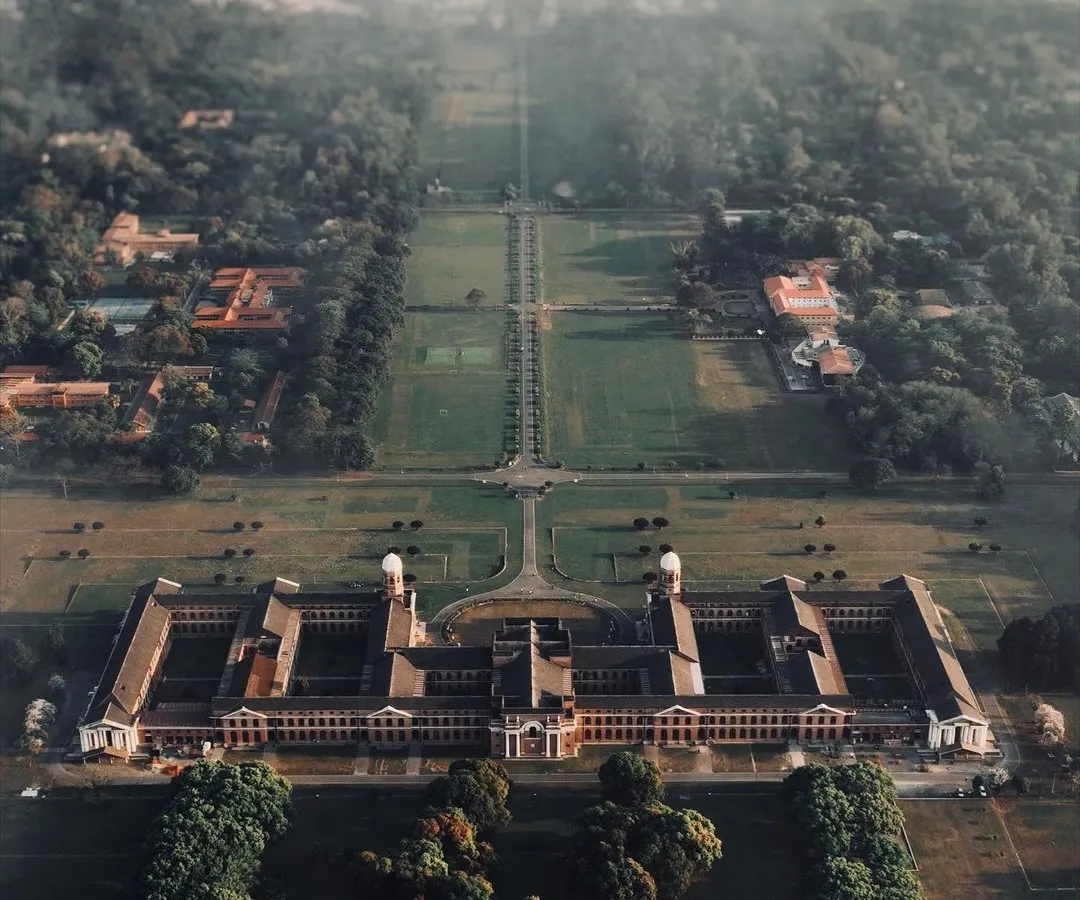 The beauty of architecture is often in its symmetry, something you can only truly appreciate from above. This top-down drone shot captures the incredible scale and design of this building surrounded by nature.