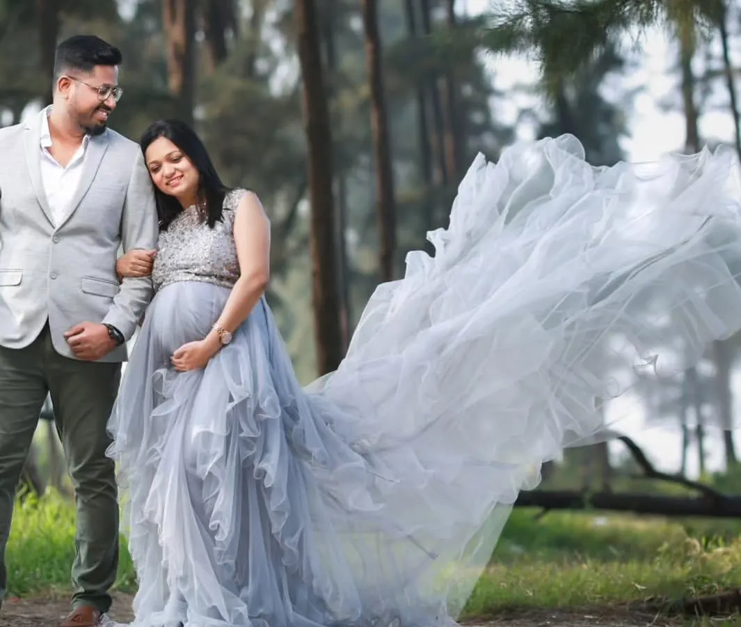 Celebrate your journey together. This photo shows our popular grey embellished trail gown, perfect for couple photoshoots. We also offer coordinating blazers for dads-to-be to complete the look.