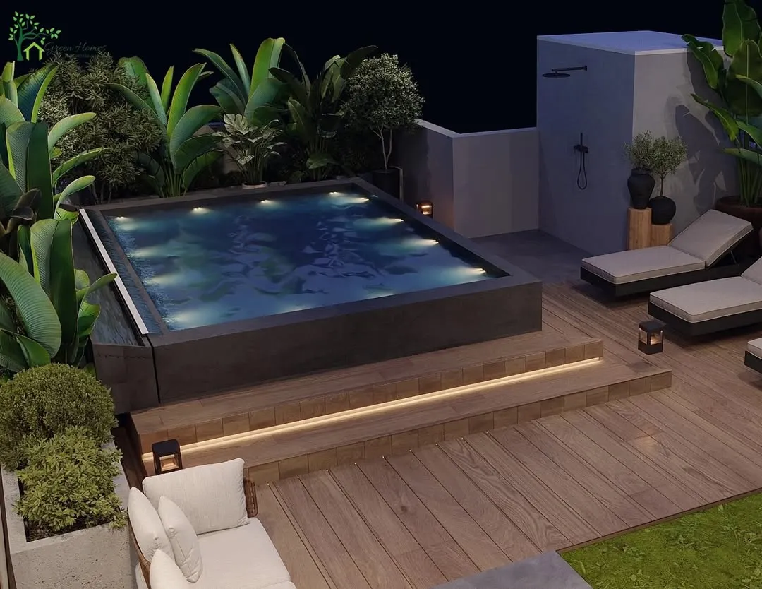 We transformed this Gurugram rooftop into a private oasis with a custom-built pool. The design features warm, integrated lighting under the steps, comfortable lounge chairs, and lush tropical plantscaping to create a resort-like feel right at home.